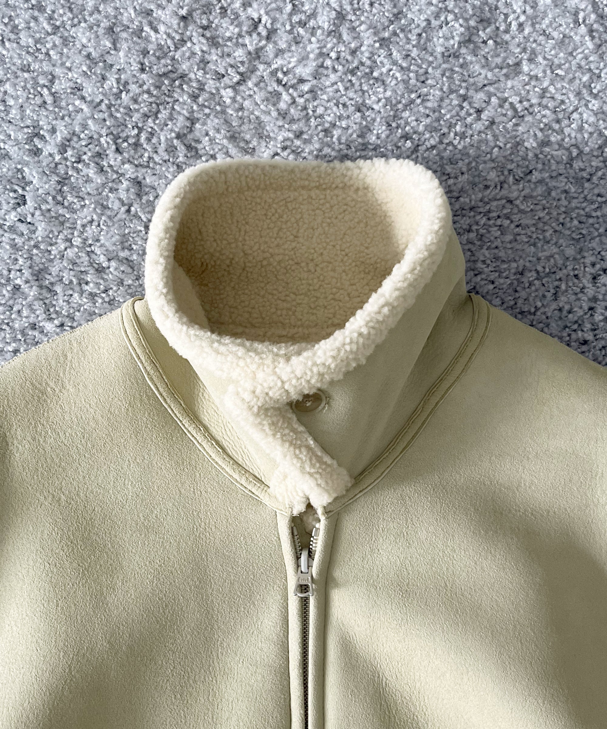 AURALEE Merino mouton zip blouson “IVORY LIME”